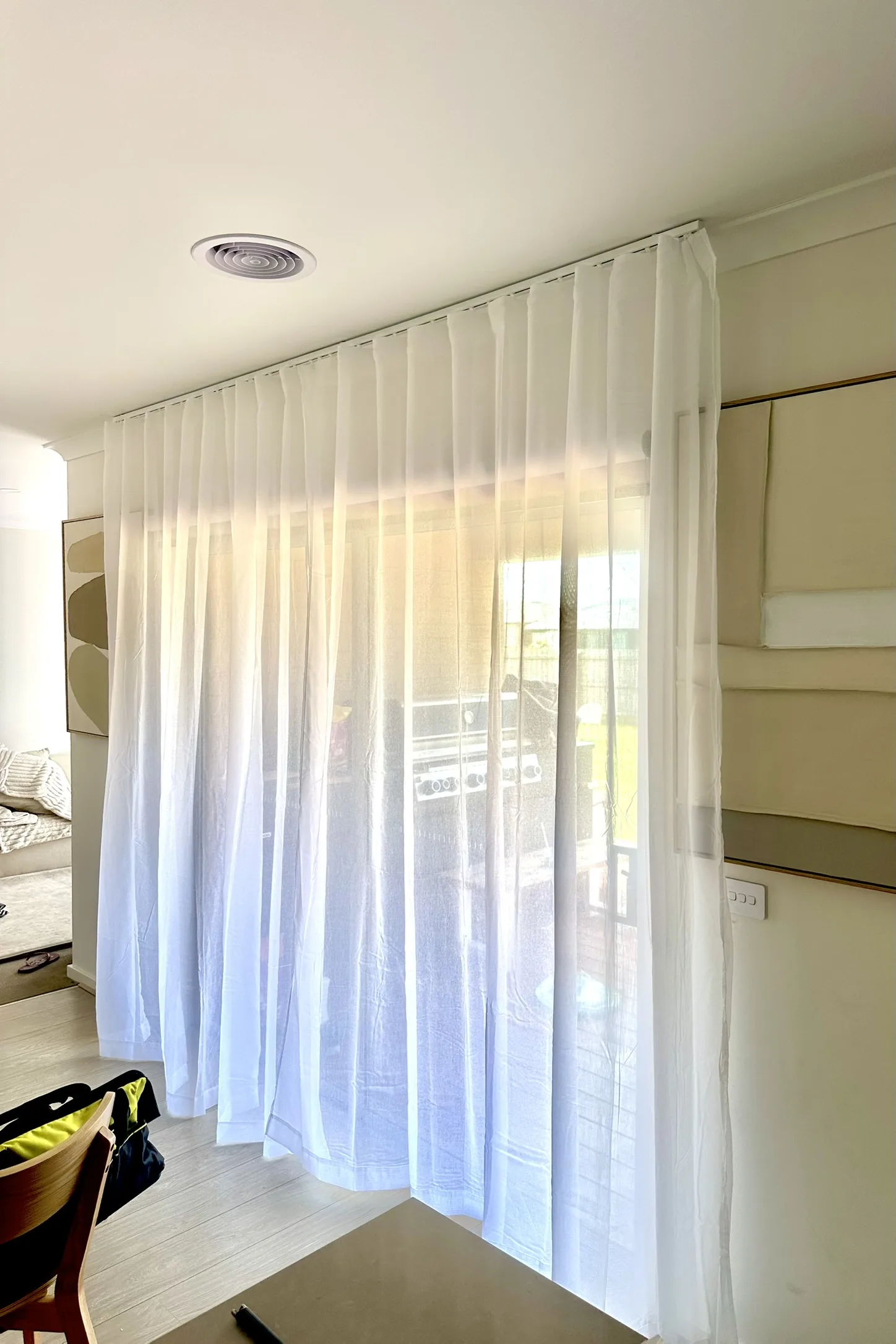 Ceiling-mounted tracked sheers installed across multiple rooms to add privacy, soften natural light and give the home a more refined, finished look.