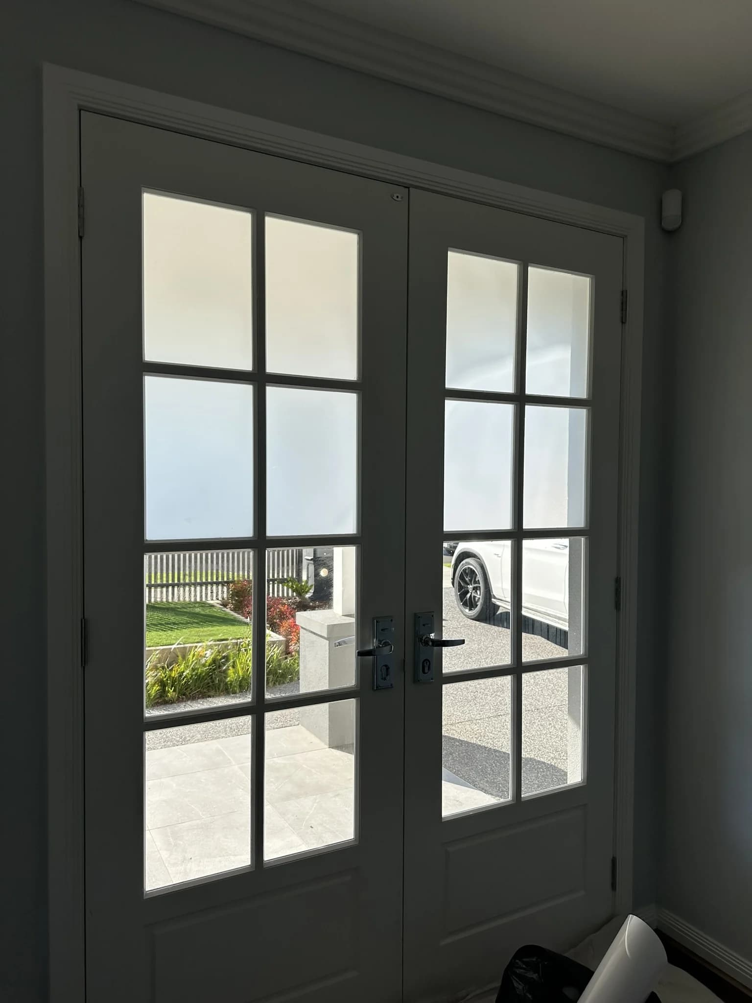 This front entry was fitted with frost tint to improve privacy while still allowing natural light through the home. Before the tint, the glass panels gave a clear view straight into the double-storey property. Now the entrance feels more private, refined and finished without taking away from the classic look of the doors.