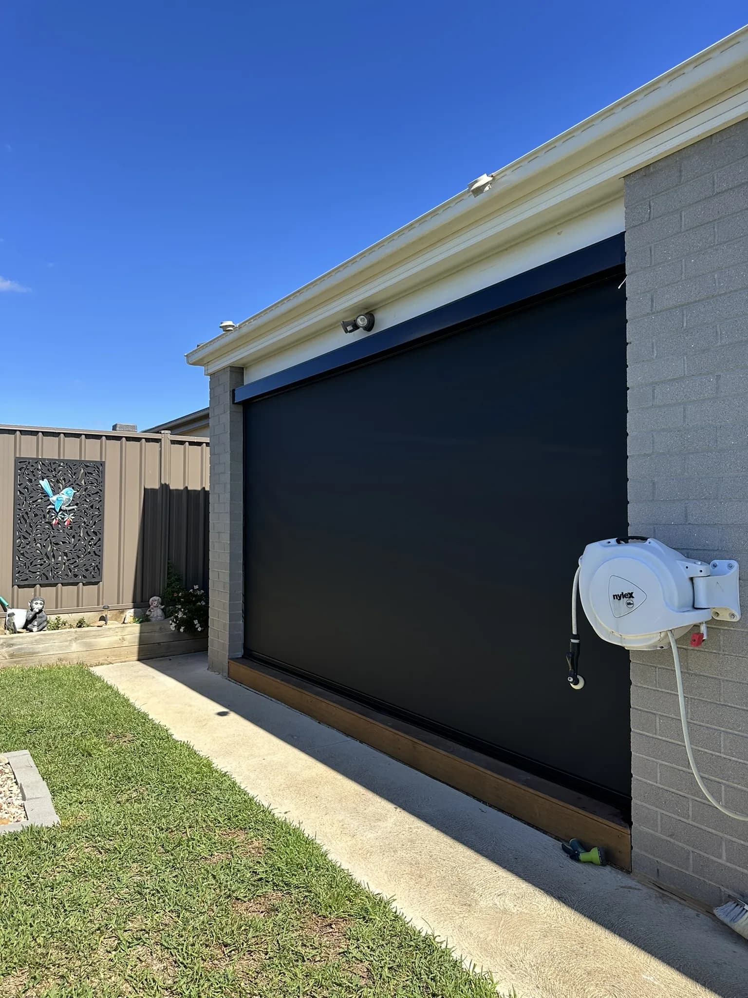 Motorised outdoor blinds installed to a pergola area, providing push-button control over sun, wind and privacy for year-round alfresco use.