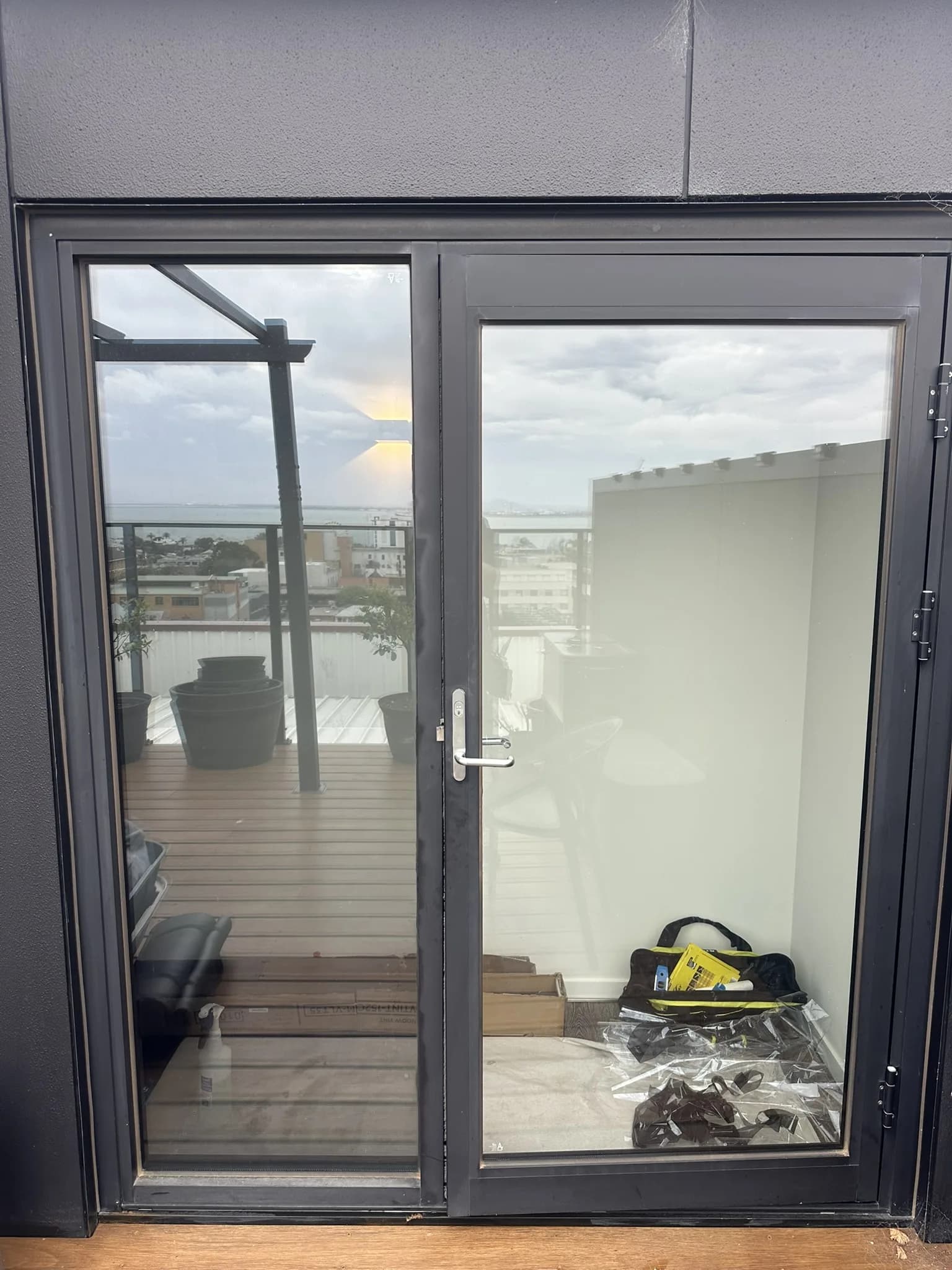 30% tint installed to a penthouse rooftop door and bathroom window to reduce heat, soften glare and improve privacy while maintaining natural light and views.