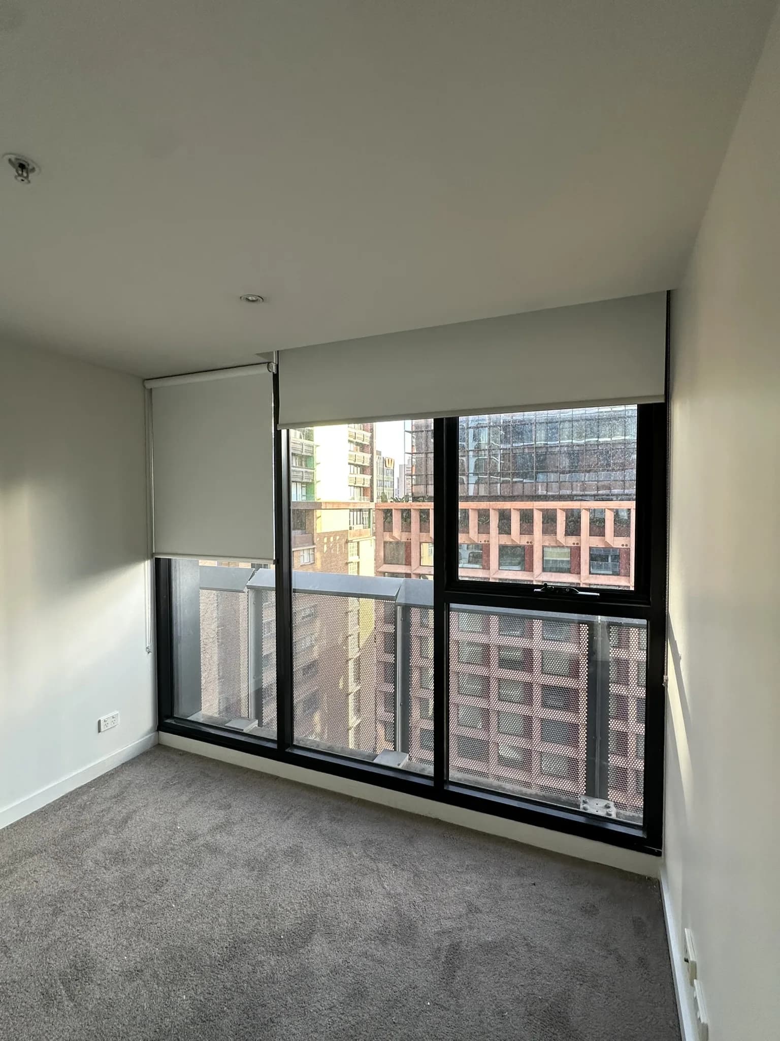 Roller blinds supplied and installed in a freshly renovated CBD apartment, completing the modern interior with clean lines, privacy and flexible light control.
