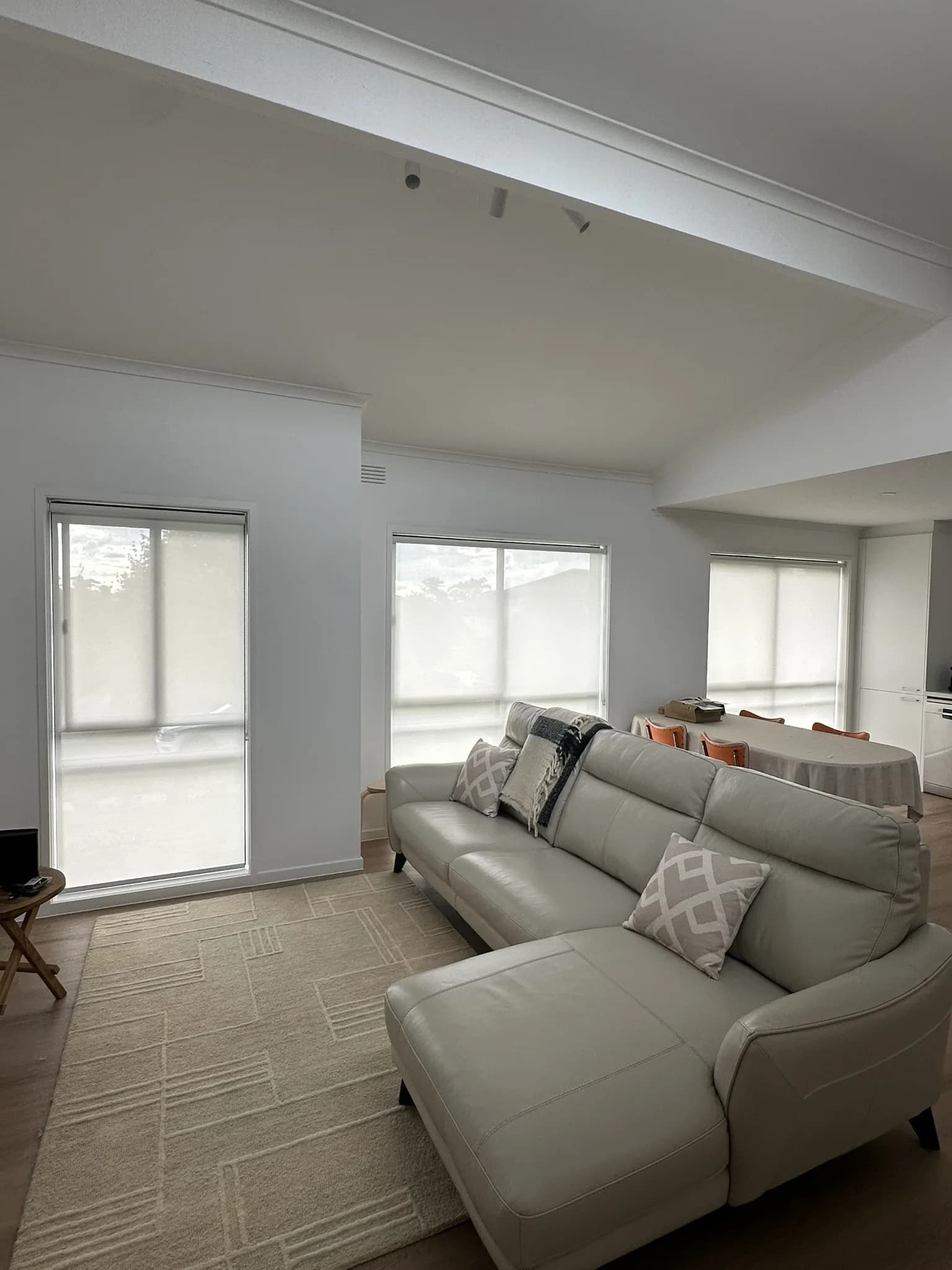 Screen roller blinds installed on street-facing windows to reduce glare and improve daytime privacy while keeping the rooms bright and views intact.